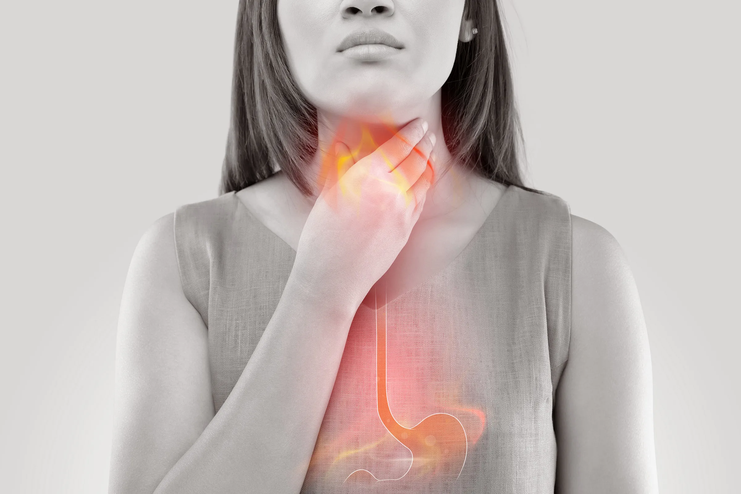 Patient holding chest in pain experiencing acid reflux